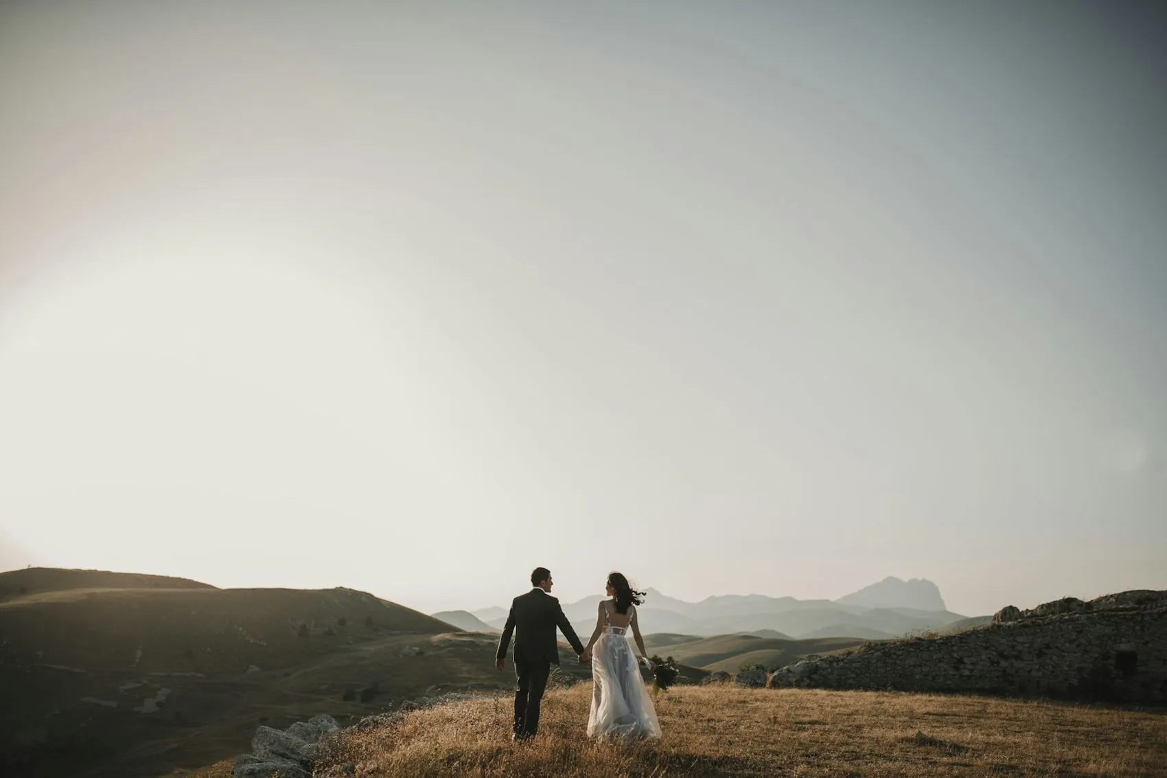 A couple walking across an open coastal landscape