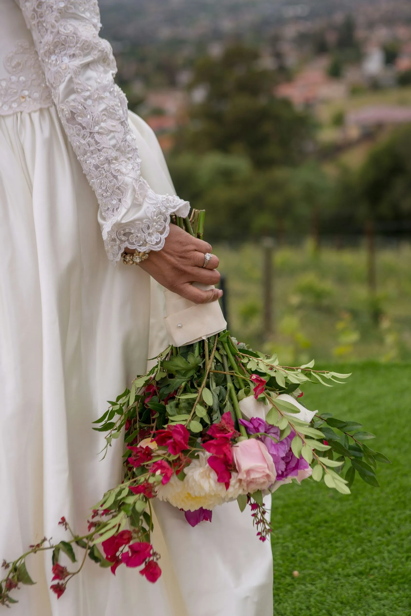 A bouquet held against a vineyard backdrop